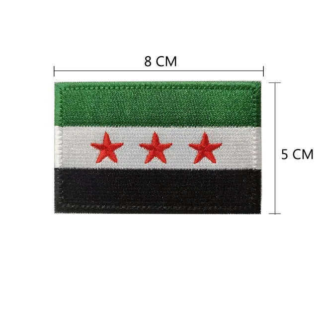A rectangular embroidered flag patch featuring horizontal stripes of green, white, and black with three red stars.