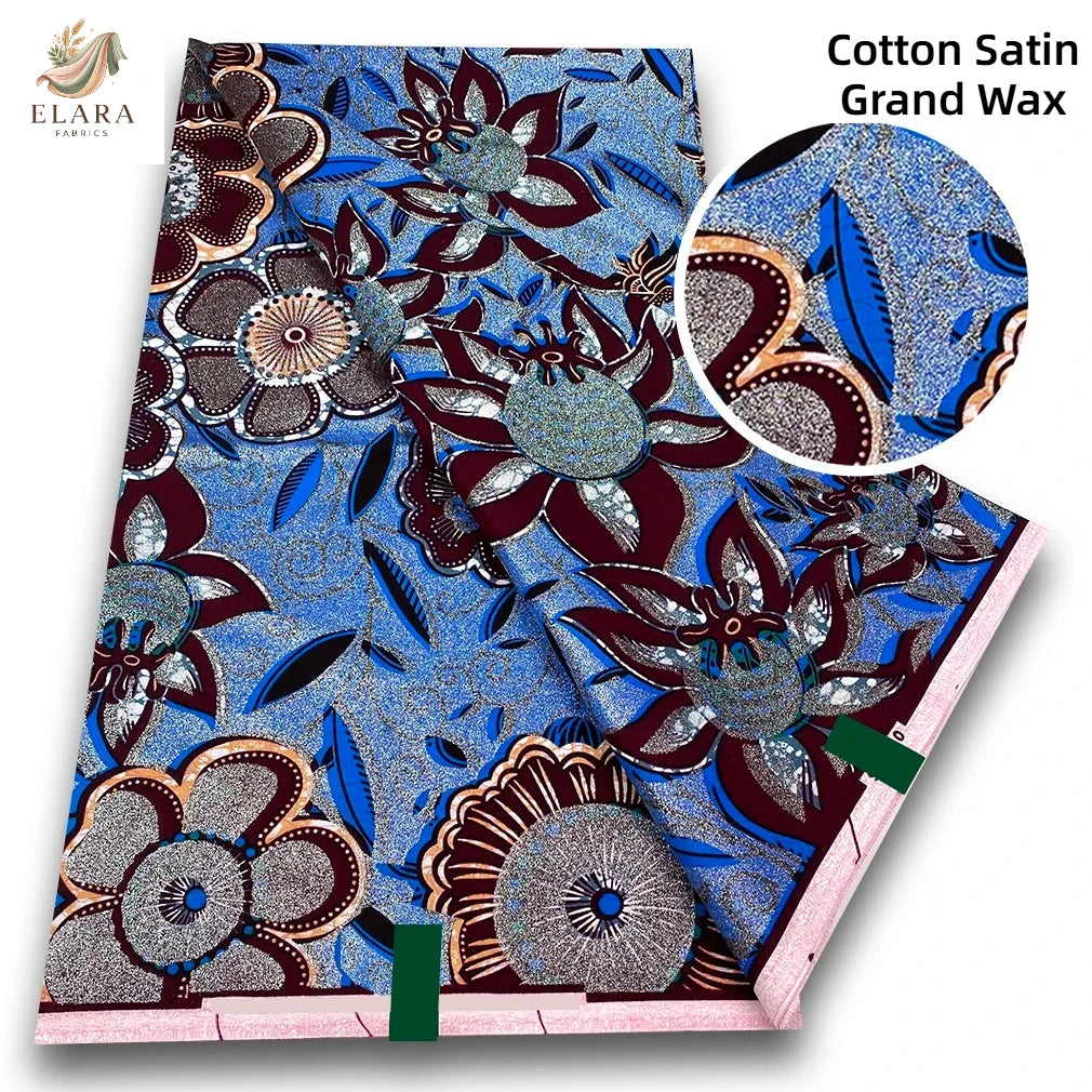 A bolt of pink glitter African wax print fabric featuring intricate floral patterns and blue accents.