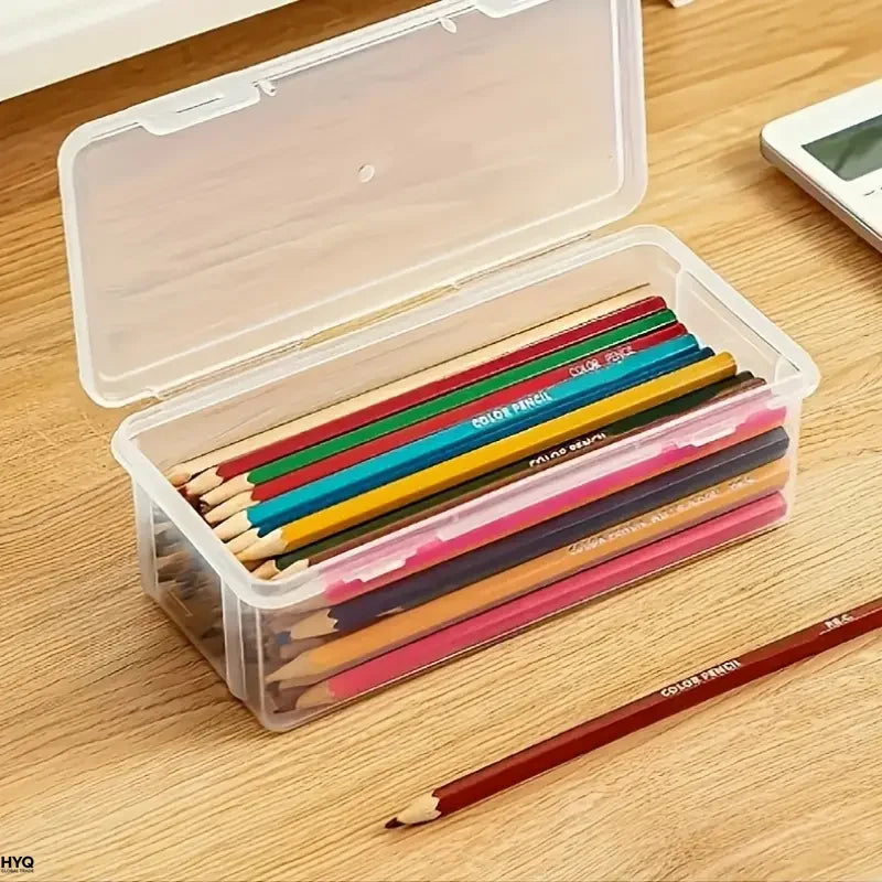 Clear plastic storage box with a lid filled with various colored pencils on a wooden surface.