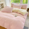 Pink and white gingham duvet cover set with two pillows on a bed