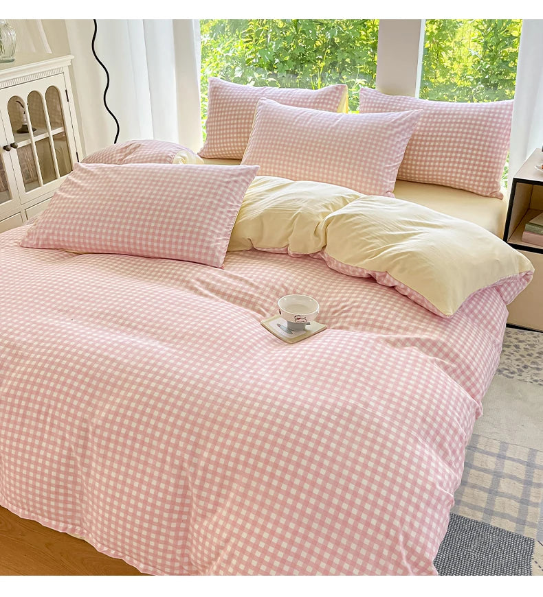 Pink and white gingham duvet cover set with two pillows on a bed