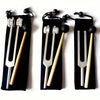 A set of three tuning forks with wooden handles and metal prongs displayed against a black background.