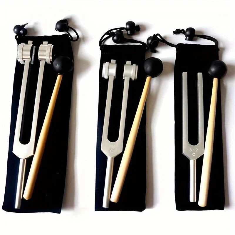 A set of three tuning forks with wooden handles and metal prongs displayed against a black background.
