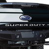 Rear view of a black Ford Super Duty truck tailgate with the Ford emblem and Super Duty lettering.