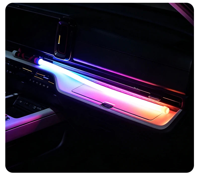 A rechargeable LED camping lantern with a flexible hands-free design is shown illuminated in a dark vehicle interior.