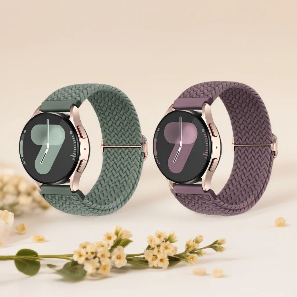 A pair of dark green and purple braided nylon watch bands displayed on a light background.