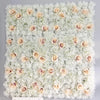 A wall panel covered in white and blush pink silk rose flowers for weddings and events