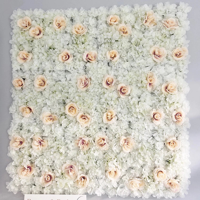 A wall panel covered in white and blush pink silk rose flowers for weddings and events