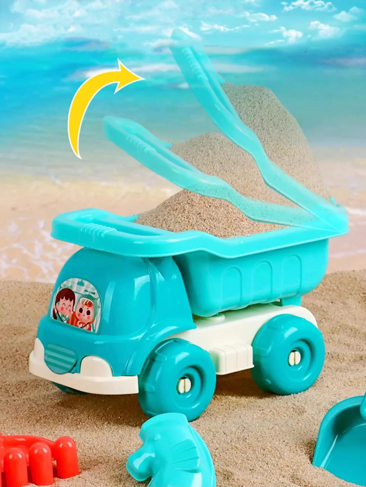 A blue toy vehicle carrying a light gray sand shovel, set in a sandy environment.