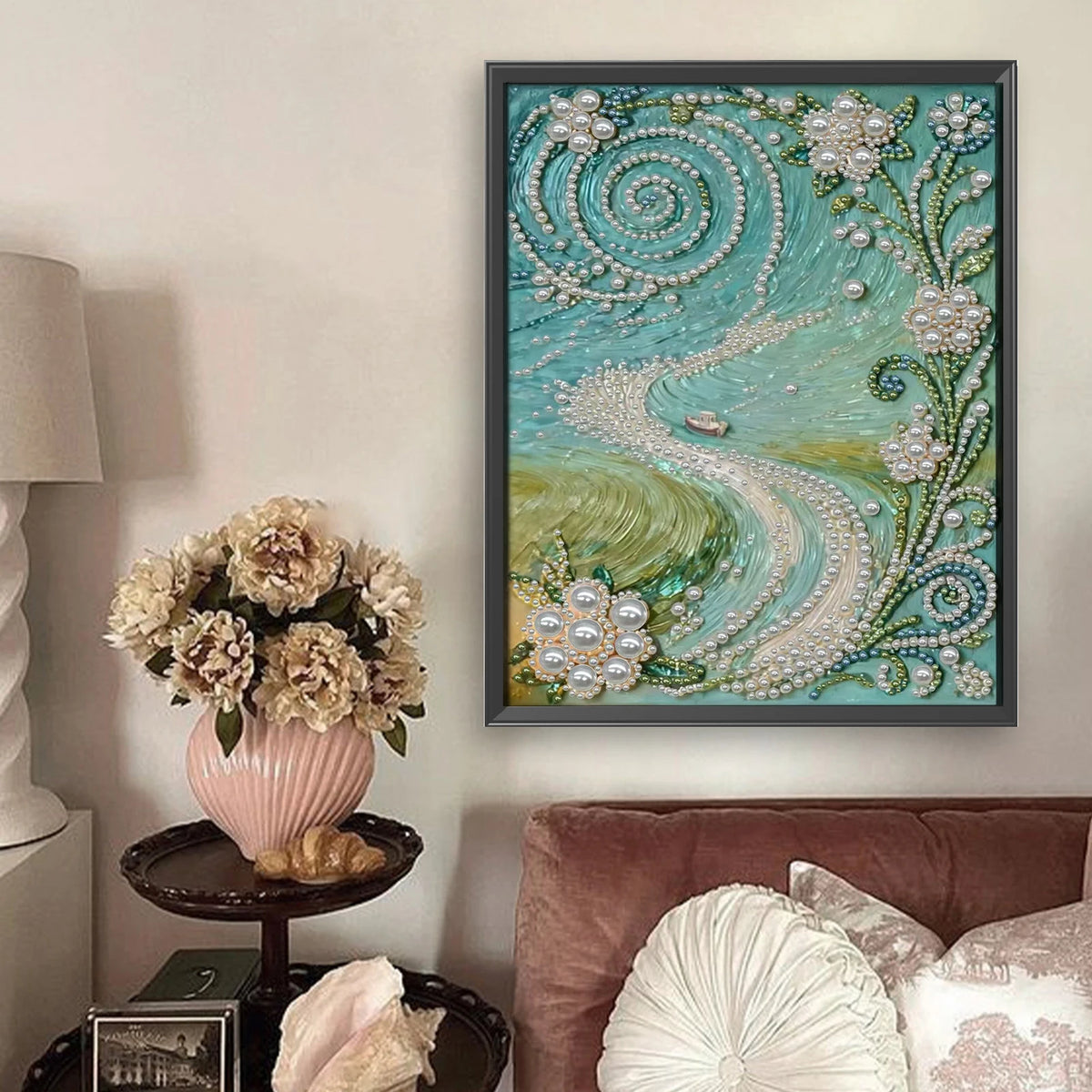 A framed painting featuring a swirling turquoise and green design of pearls and foliage on a light background.