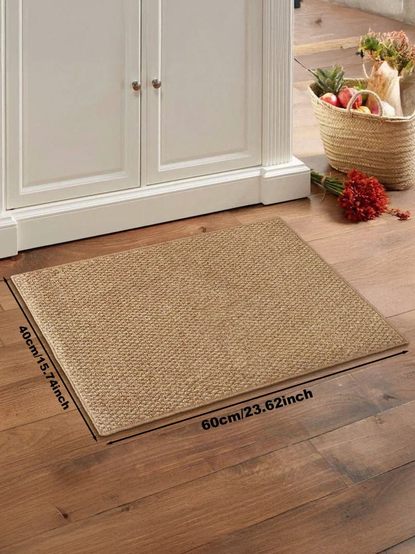 A rectangular beige faux sisal non-slip kitchen runner rug placed on a wooden floor.