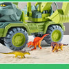 A green transport truck loaded with various dinosaur figures on a sandy surface.