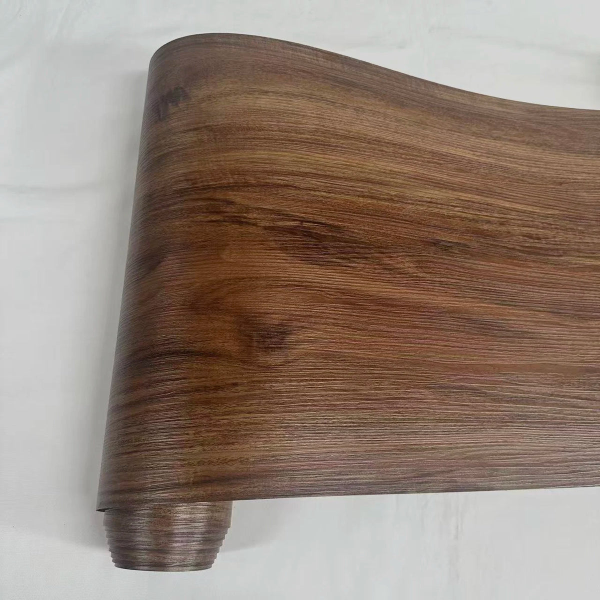 A close-up view of a brown wood grain peel and stick wall decal.