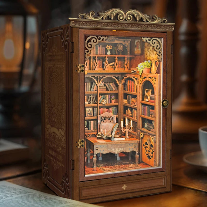 A detailed miniature wooden book house shelf insert with built-in lighting and decorative elements.