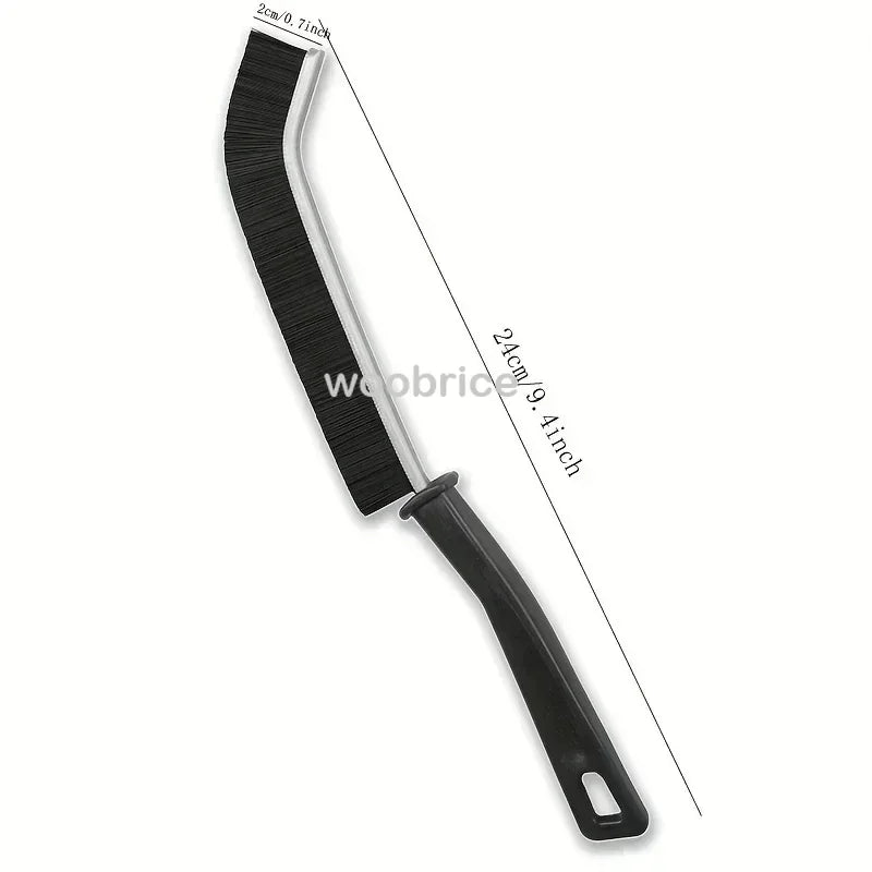 A black multifunctional crevice cleaning brush with a long handle and bristles.