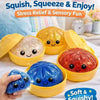 A hand holds a blue glitter squishy stress relief toy in a yellow container with other colorful squishies.