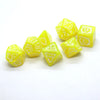 A set of yellow polyhedral dice, including a d6 and d8, with silver dragon embellishments.