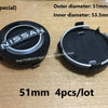 A set of four black wheel center hub caps for Nissan models, showing the outer and inner diameters.
