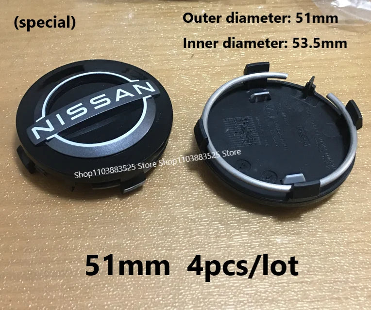 A set of four black wheel center hub caps for Nissan models, showing the outer and inner diameters.