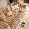 A beige plush sofa cushion cover featuring tufted texture and decorative pillows on a light-colored sofa.