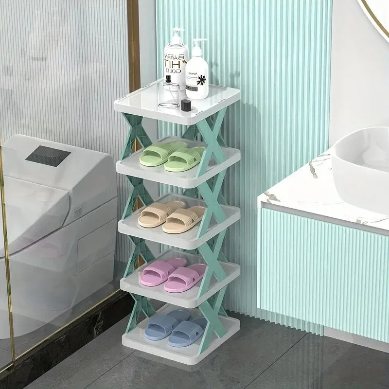 A white 9-tier vertical shoe rack with light green accents displaying various pairs of shoes.