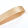 A roll of beige double face satin ribbon, shown in profile view.