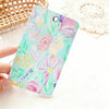 A pink and green floral patterned PU leather card holder keychain is held by a hand on a white surface.