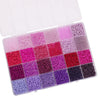 A plastic box containing 5200 glass rice beads in various shades of pink, purple, and magenta for jewelry making
