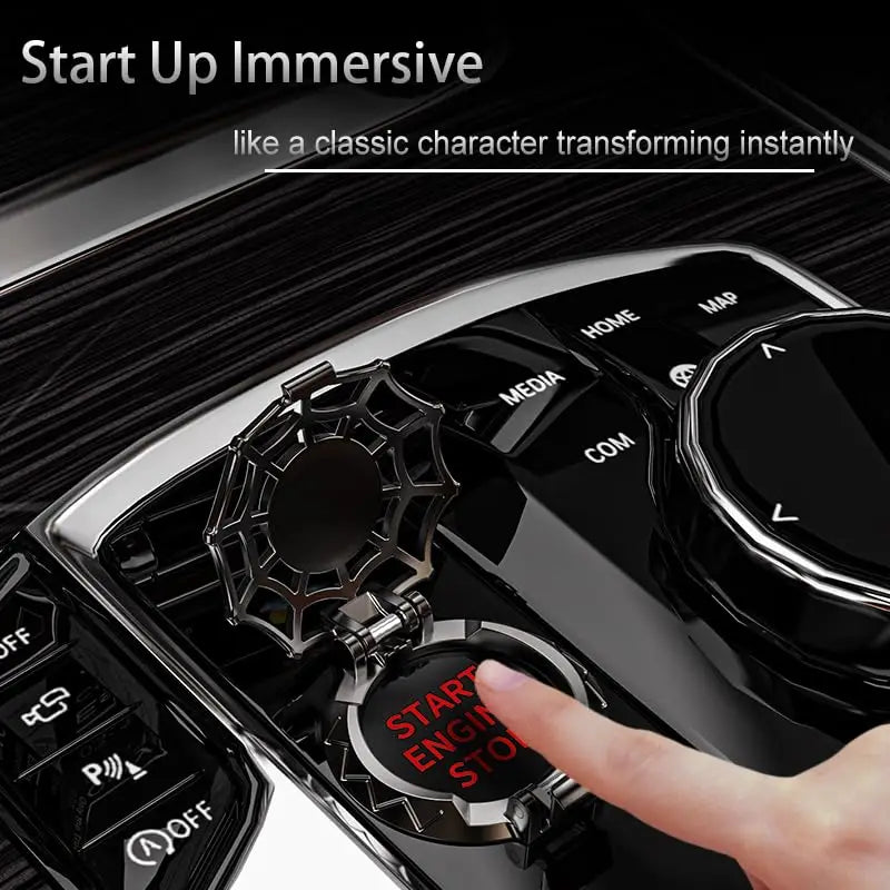 A hand presses the start engine button on a black car ignition, demonstrating an immersive start-up feature.
