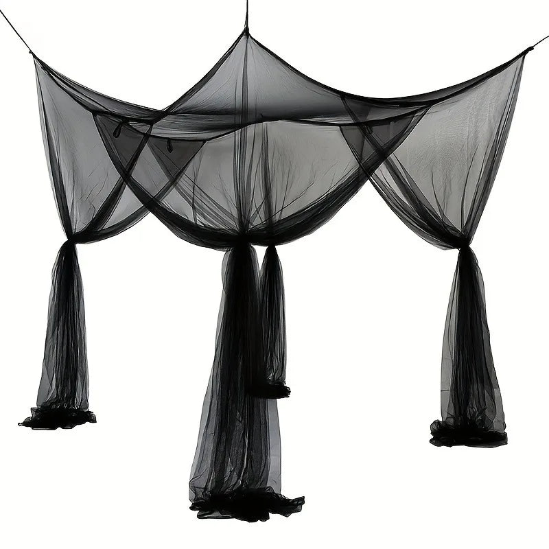 Black floor-to-ceiling mosquito net with a double opening draped in the air.