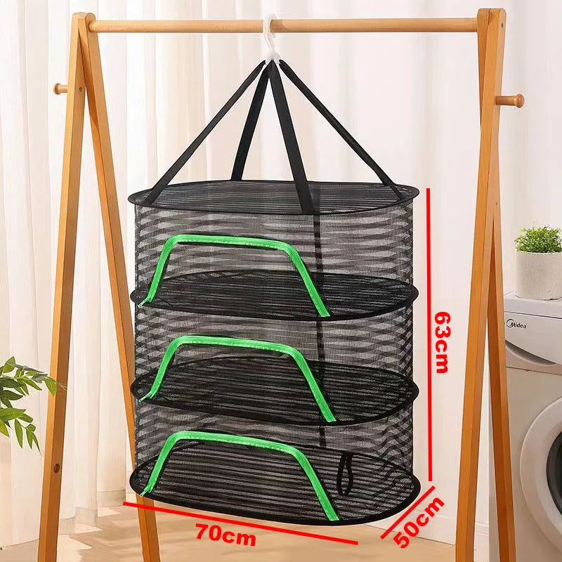 A folding wooden rack holds a black mesh hanging drying net with green accents.