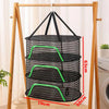 A folding wooden rack holds a black mesh drying net with green accents, showing its dimensions.
