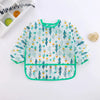 A light blue and green patterned kids waterproof long sleeve smock and feeding bib