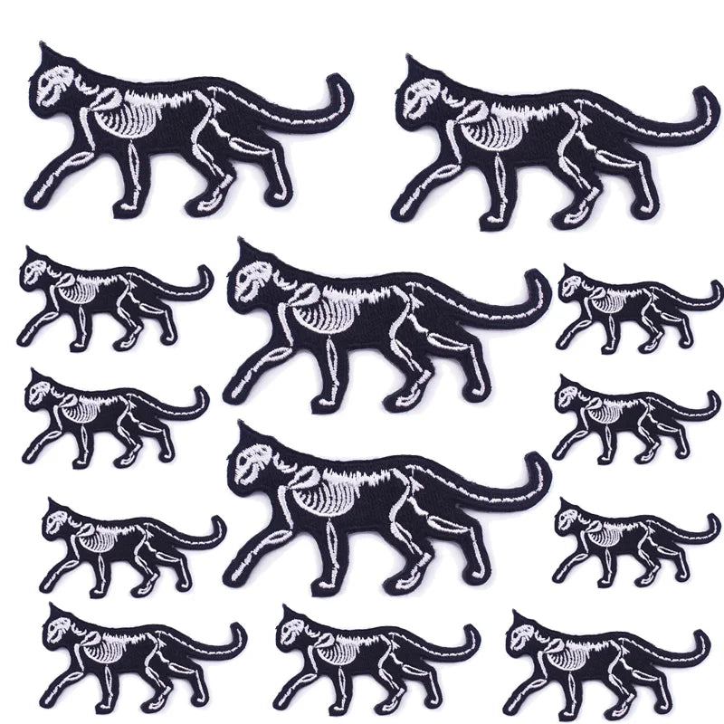 A set of ten black and white embroidered iron-on patches depicting stylized cats or panthers in various poses.