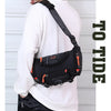 A person wearing a black tactical chest bag with an orange accent is shown against a white background.