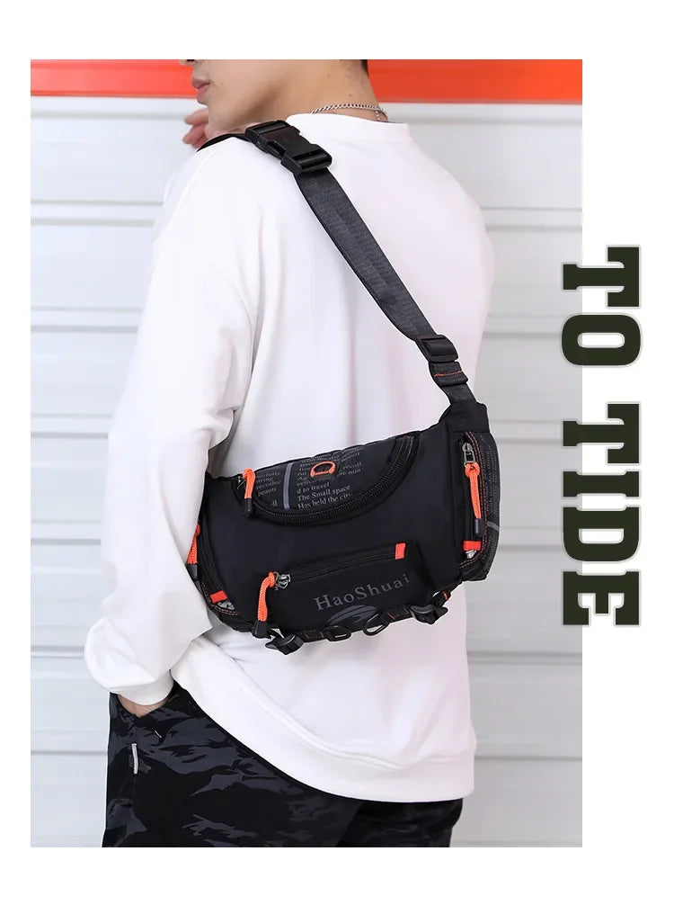 A person wearing a black tactical chest bag with an orange accent is shown against a white background.