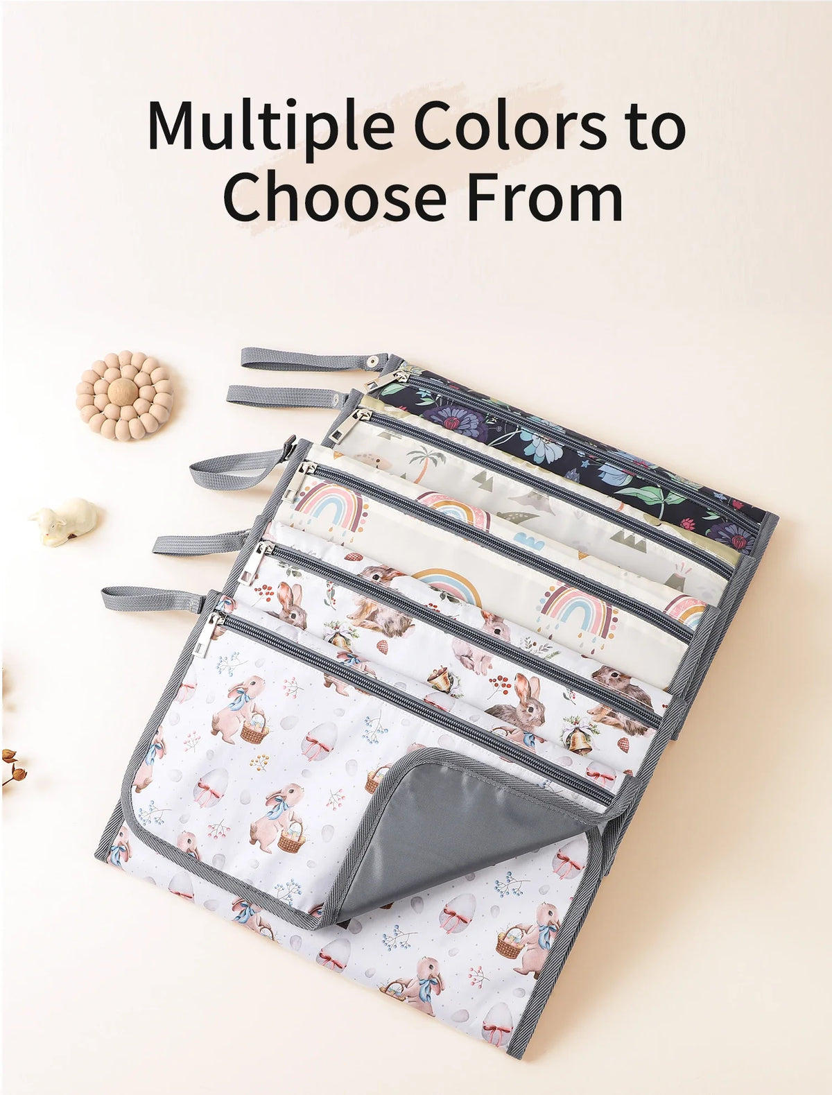 A collection of multiple colored foldable baby changing mats and storage bags displayed on a light background.