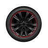 A close-up view of a black car wheel rim protector trim with a red edge guard ring.
