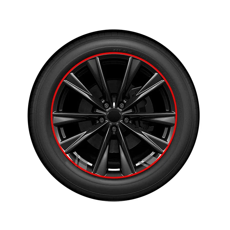 A close-up view of a black car wheel rim protector trim with a red edge guard ring.