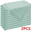 A stack of six light mint green raw-edge polyester cloth napkins.