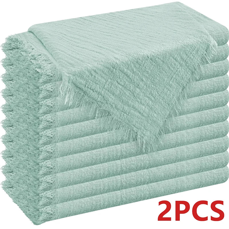 A stack of six light mint green raw-edge polyester cloth napkins.