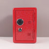 A red vintage metal piggy bank with a combination lock and key.
