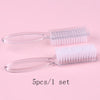 A set of five clear plastic nail art brushes with long handles displayed on a pink background.
