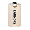 A tall, beige foldable laundry basket with black padded handles.