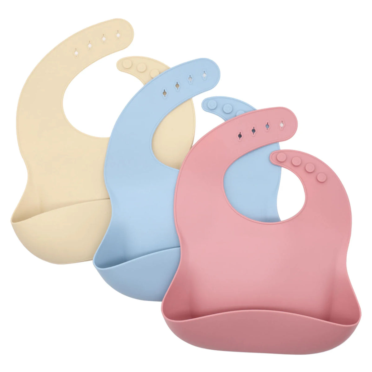 Three silicone baby bibs in cream, light blue, and pink with food catcher pockets.