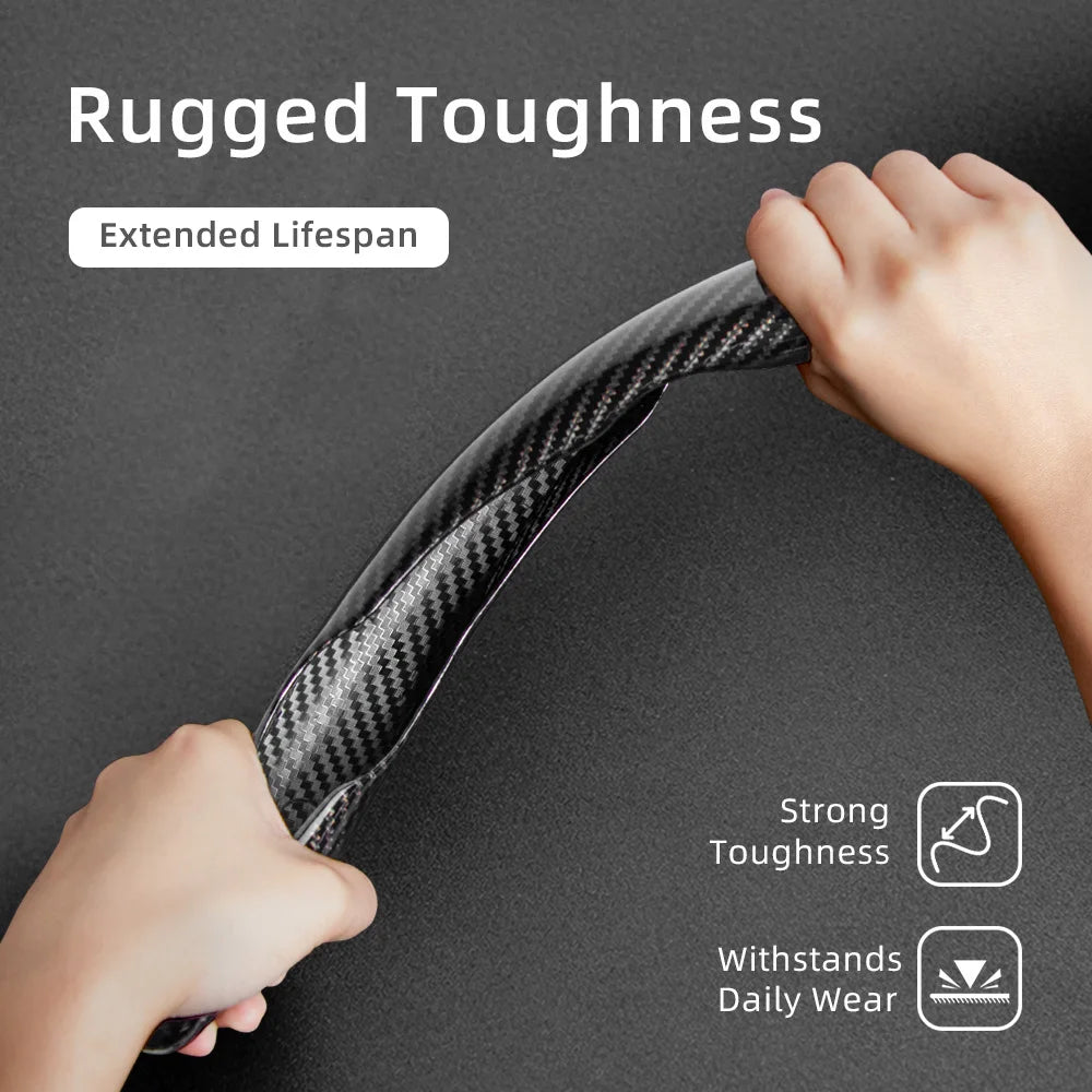 A hand is holding a black carbon fiber texture steering wheel cover, demonstrating rugged toughness and extended lifespan.