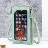 A light mint green hands-free crossbody phone bag with a clear window showing a smartphone interface.