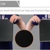 A black gaming mouse pad is shown being held by hands, highlighting the durable anti-slip back detail.