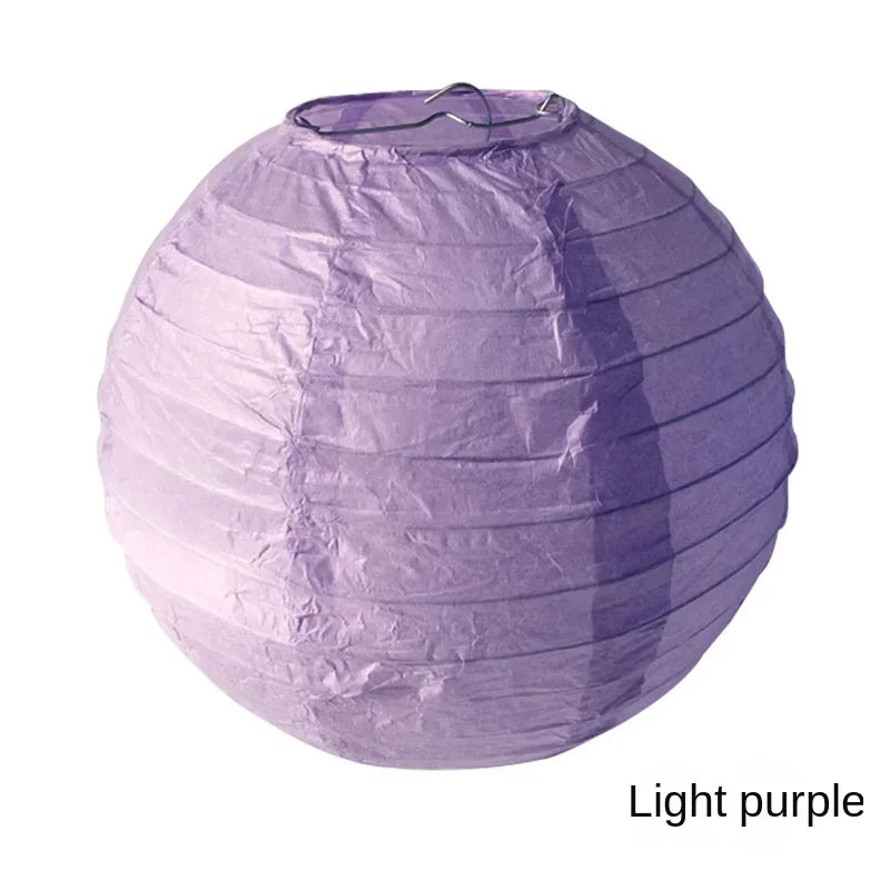 A purple paper lantern with a gathered top, used as a light source.