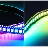 An individually addressable RGB LED strip light curving across a dark background, displaying a rainbow spectrum of colors.